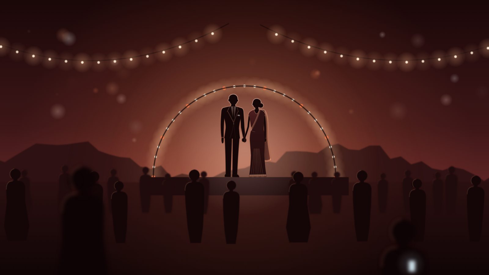An evening wedding reception on a lawn, the couple under an arch of lights